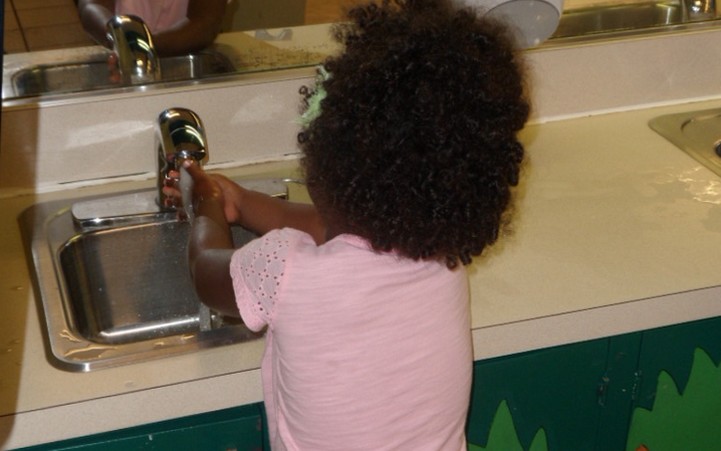 Girl washing her hands