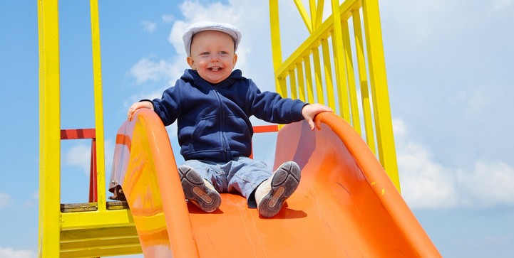 Toddler boy on slide