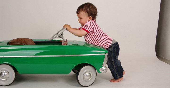 Toddler pushing toy car